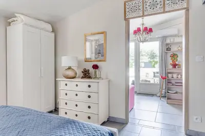 a bedroom with a bed and a dresser and a mirror at Le Parc in Carpentras