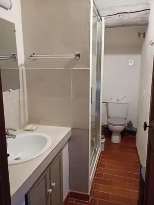 a bathroom with a sink and a toilet at Le Tilleul in Lacoste