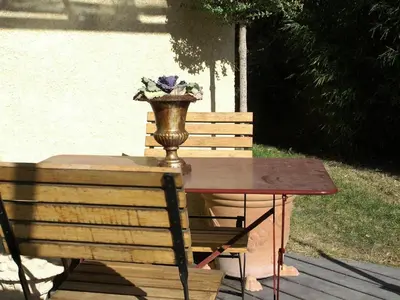 a wooden table with a flower arrangement on top of it at Le Cezanne in Aix-en-Provence