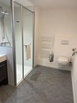 a bathroom with a toilet and a glass shower at DOMITYS LES TOURMALINES in Carpentras