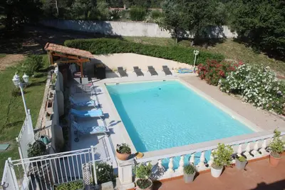 an overhead view of a swimming pool with chairs and plants at les lauriers de Joelle in Peyrolles-en-Provence