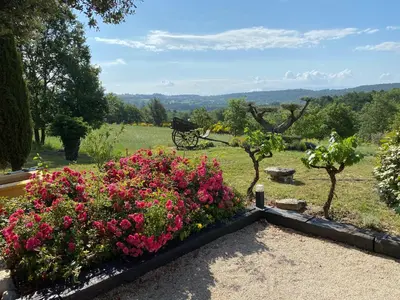 a garden with flowers and a bench in a field at Location bastide provencale Luberon in Murs