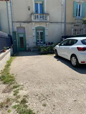 a white car parked in front of a building at Côté Court in LʼIsle-sur-la-Sorgue