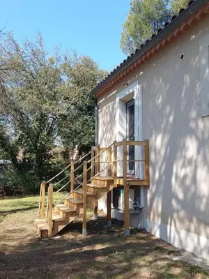 a wooden deck on the side of a building at Maison d'Hôtes & Spa La Chêneraie-Provence Ventoux in Saint-Didier