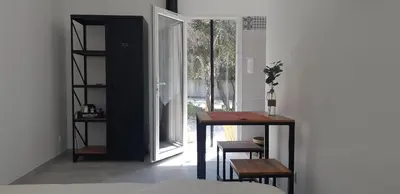 a table and chairs in a room with a window at Maison d'Hôtes & Spa La Chêneraie-Provence Ventoux in Saint-Didier
