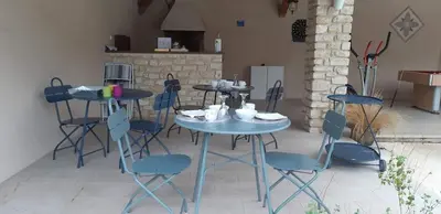 a blue table and chairs with cups and plates on it at Maison d'Hôtes & Spa La Chêneraie-Provence Ventoux in Saint-Didier