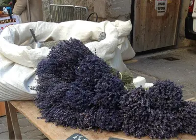 a pile of purple flowers on a wooden table at LOlivier sur le Toit in LʼIsle-sur-la-Sorgue