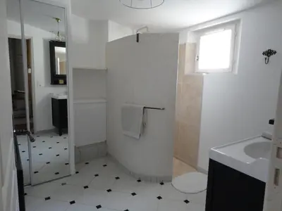 a bathroom with a toilet and a sink and a window at LOlivier sur le Toit in LʼIsle-sur-la-Sorgue