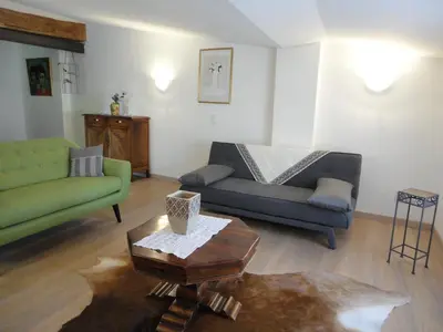 a living room with two couches and a coffee table at LOlivier sur le Toit in LʼIsle-sur-la-Sorgue