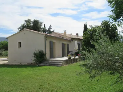 a small white house with a grass yard at LA MASTRONA in Saumane-de-Vaucluse
