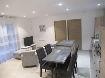a kitchen and dining room with a table and chairs at LA MASTRONA in Saumane-de-Vaucluse