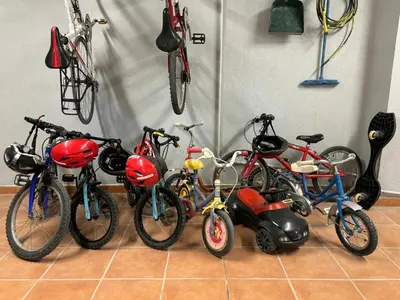 a group of bikes and scooters in a garage at Mas d'Olea - heated swimming pool - airco - 14pers in Lauris