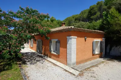 a small orange building in a field with a tree at La Petite Maison - Mas des Sous Bois in Ventabren