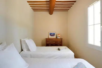 a bedroom with two beds and a dresser at La Petite Maison - Mas des Sous Bois in Ventabren