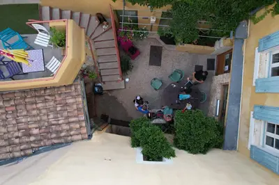 an overhead view of a building with a garden and people at Gîte de l'ASPA in Saint-Christol