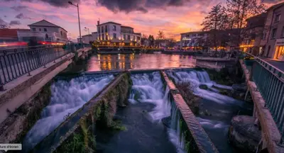 a city lit up with christmas lights next to a body of water at LA PERLE DE PROVENCE-Magnifique Vue CLIM LINGE Golf Saumane 6P Piscine Tennis in Saumane-de-Vaucluse