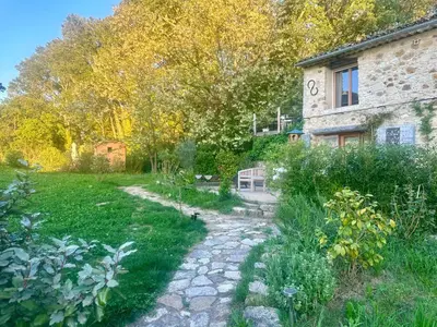 a patio with a couch and a table on a wooden deck at La Source in Rustrel