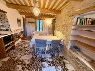 a bedroom with a white bed and a window at La Source in Rustrel