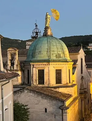 a building with a statue on top of it at Appartement de charme au calme avec piscine, au pied du Colorado provençal, cœur du Luberon in Rustrel