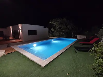 a swimming pool in a yard at night at Villa la Provence, Luxe, Confort et Joie de Vivre in Carpentras