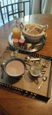 a table with a tray of food on a table at L'atelier de Guytou et Spa in Cheval-Blanc
