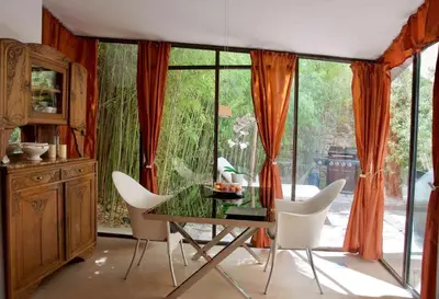 a dining room with a glass table and white chairs at LASUITE Domaine Bertuli, heated Pool, Aircon in Oppède