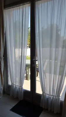 an open door with white curtains in a room at Provence Luberon Goult Gite Mafasuza in Goult