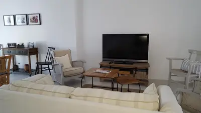 a living room with a couch and a flat screen tv at Provence Luberon Goult Gite Mafasuza in Goult