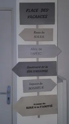 a bunch of signs on a wall next to a door at Provence Luberon Goult Gite Mafasuza in Goult