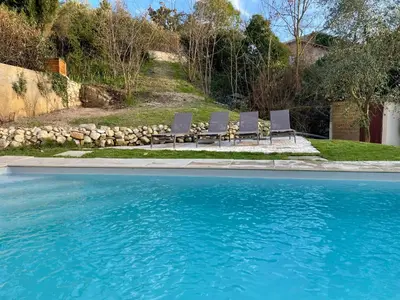 a group of chairs sitting next to a swimming pool at Maison & Jardin Coeur Luberon classé 4 étoiles in Peypin-dʼAigues