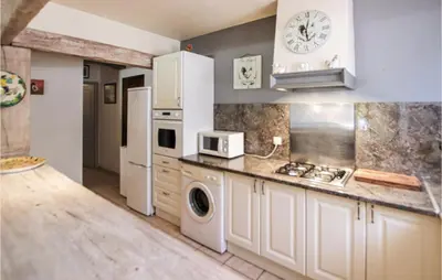 a kitchen with a white refrigerator and a microwave at Cozy Home In Carpentras in Carpentras