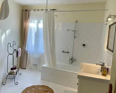 a bathroom with a shower and a tub and a sink at Villa Velleron - Bed and Breakfast in Velleron