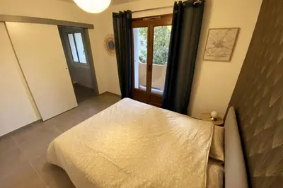 a bedroom with a bed and a large mirror at Appartement T2 Cosy sur Aix in Aix-en-Provence