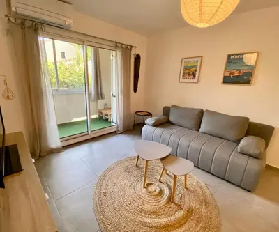 a living room with a couch and a table at Appartement T2 Cosy sur Aix in Aix-en-Provence