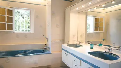 a bathroom with two sinks and a large mirror at Chambres dans le Luberon - Bois Romay in La Bastide-des-Jourdans