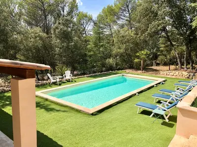 a swimming pool with lounge chairs and a lawn at Chambres dans le Luberon - Bois Romay in La Bastide-des-Jourdans