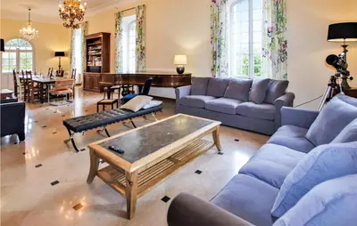 a living room with blue couches and a table at 7 Bedroom Nice Home In Apt in Apt