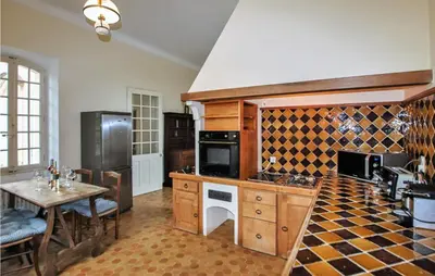 a kitchen with a table and a stove top oven at 7 Bedroom Nice Home In Apt in Apt