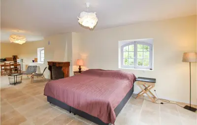 a bedroom with a bed and a living room at 7 Bedroom Nice Home In Apt in Apt