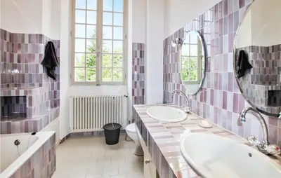 a bathroom with two sinks and a large mirror at 7 Bedroom Nice Home In Apt in Apt