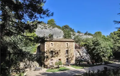 an old stone house on a hill with trees at 2 Bedroom Amazing Home In Apt in Apt