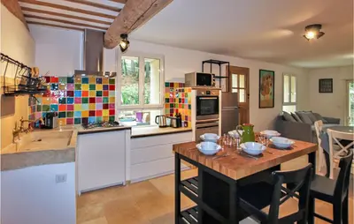 a kitchen with a wooden table in a kitchen with a tableablish at 2 Bedroom Amazing Home In Apt in Apt