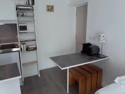 a small kitchen with a table in a room at Studio avec kitchenette du sentier des ocres in Roussillon