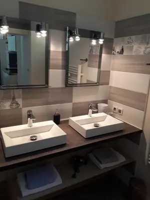 a bathroom with two sinks and a large mirror at Studio avec kitchenette du sentier des ocres in Roussillon