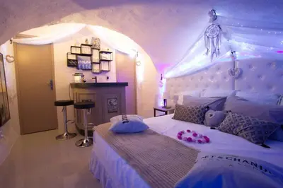 a bedroom with a large bed with a canopy at Les Secrets d'Alcôve, nuits Romantiques avec SPA in Aix-en-Provence