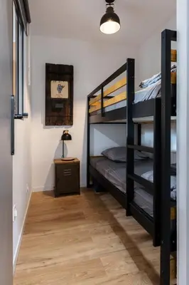 a room with two bunk beds and a table at OPEN SKY Industry Hyper Centre Fontaine Moussue in Salon-de-Provence