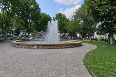 a fountain in the middle of a park at OPEN SKY Industry Hyper Centre Fontaine Moussue in Salon-de-Provence
