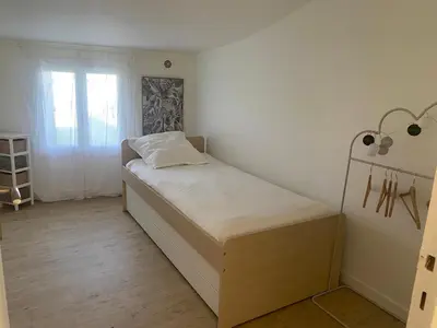 a small bedroom with a bed and a window at Il y a le Soleil, la Campagne et la Mer in Martigues