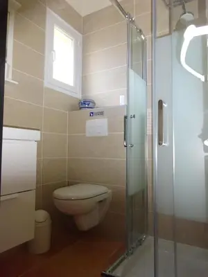 a bathroom with a toilet and a glass shower at Provence.bienvenue chez nous in Rognes