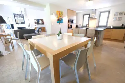 a dining table and chairs in a living room at high standard provencal bastide with heated pool in lourmarin in the luberon, vaucluse. 10 people in Lourmarin